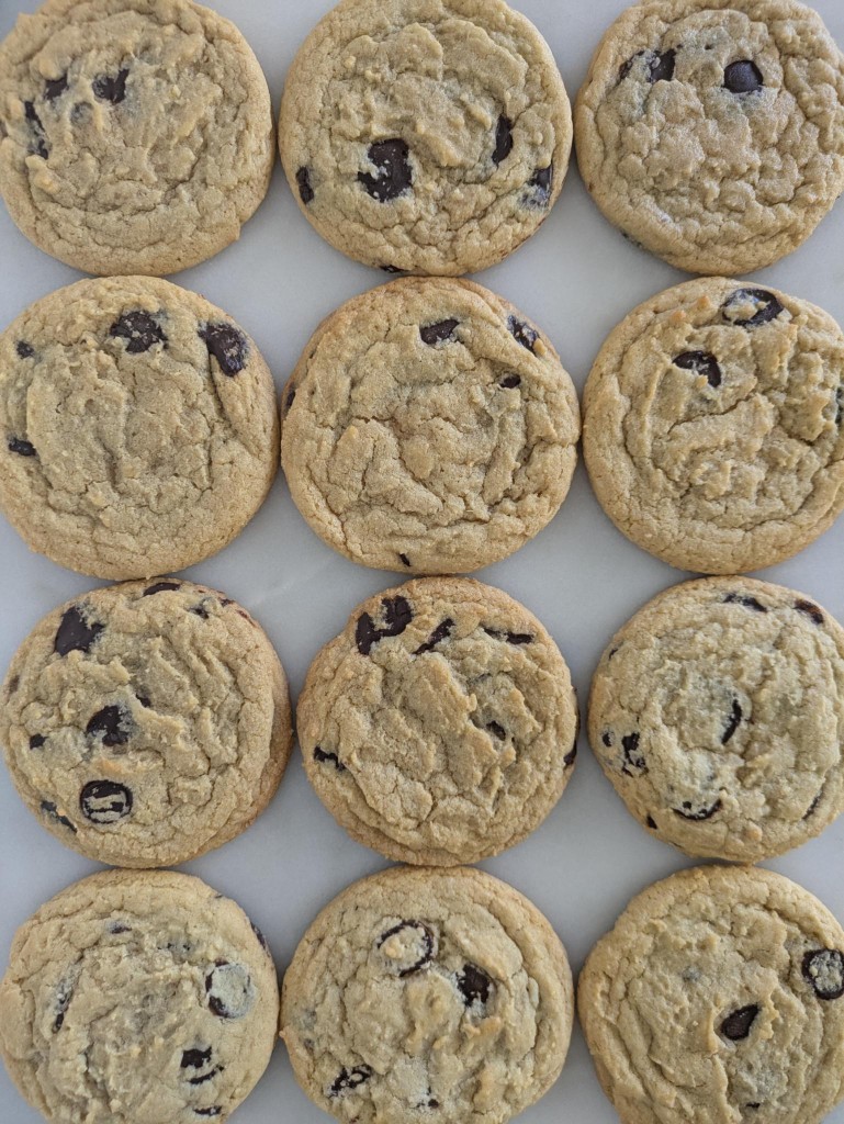 A dozen chocolate chip cookies on marble
