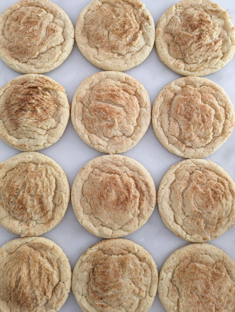 A dozen snickerdoodle cookies on marble